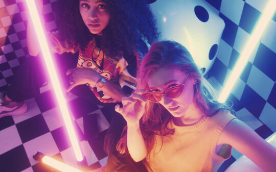 urban-girls-between-bars-of-colored-light